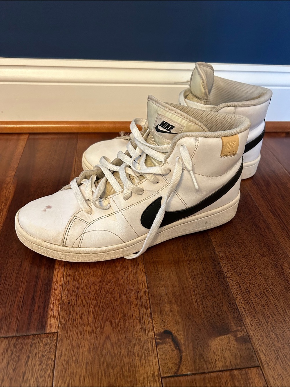 Nike White High-Top Sneakers with Black Swoosh